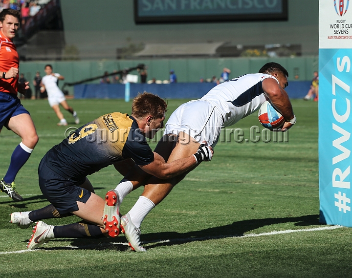 2018RugbySevensSun-20.JPG - United States player Martin Losefo scores a try in the grasp of Matias Osadczuk of Argentina in the men's championship 5th place finals of the 2018 Rugby World Cup Sevens, Sunday, July 22, 2018, at AT&T Park, San Francisco. Argentina defeated the United States 33-7. (Spencer Allen/IOS via AP)